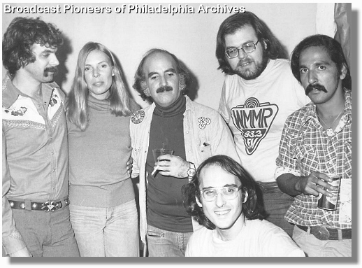 Tom Rush, Joni, Gene Shay, Ed Sciaky, Joni's road manager & Michael Tearson (seated) backstage at The Tower Theatre, Upper Darby, PA. 