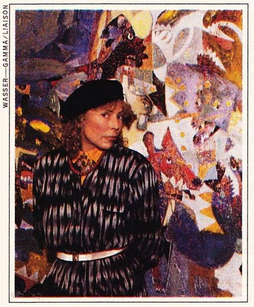 Joni in front of her painting titled <i>Dog Eat Dog.</i> 