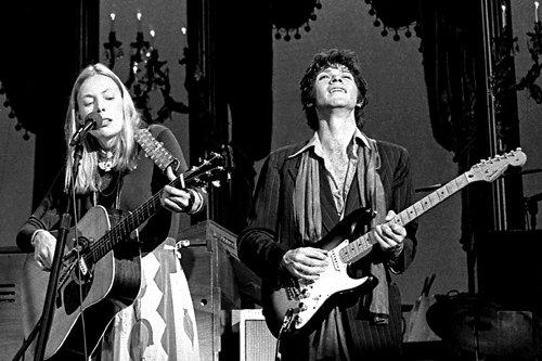 Joni and Robbie Robertson.  Photo by <a href="http://www.stevegladstone.com/maingallery.php?category_id=9&parent_id=9&photo_id=397&frompage=searchphoto&start=0" target="_blank" class="white">Steve Gladstone</a>.
