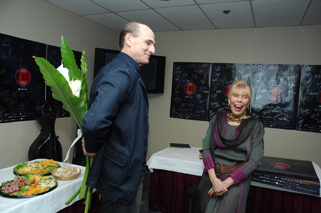 James Taylor with flowers for Joni backstage. 